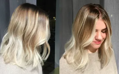 En kvinna med vackert blont hår, mjukt vågigt och med en fin ombre-effekt.