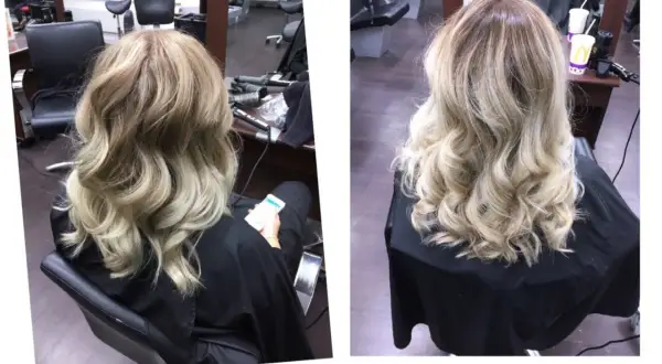 A woman's blonde hair styled in loose waves, viewed from the back.