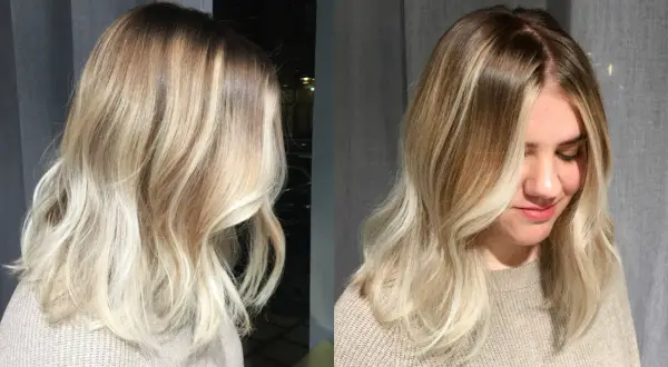 En kvinna med vackert blont hår, mjukt vågigt och med en fin ombre-effekt.